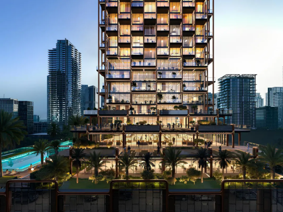 The Symphony tower at dusk with lit balconies, landscaped podium terraces and a lagoon pool